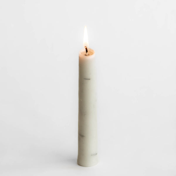 Photo of single Birch Tree candle made of 100% Canadian beeswax, burning to show interior rings, with white background.