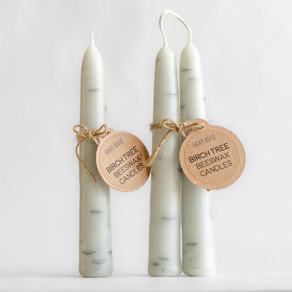 Photo of single and pair of Birch Tree candles made of 100% Canadian beeswax with Gray Buck tags, standing upright in front of a white background.