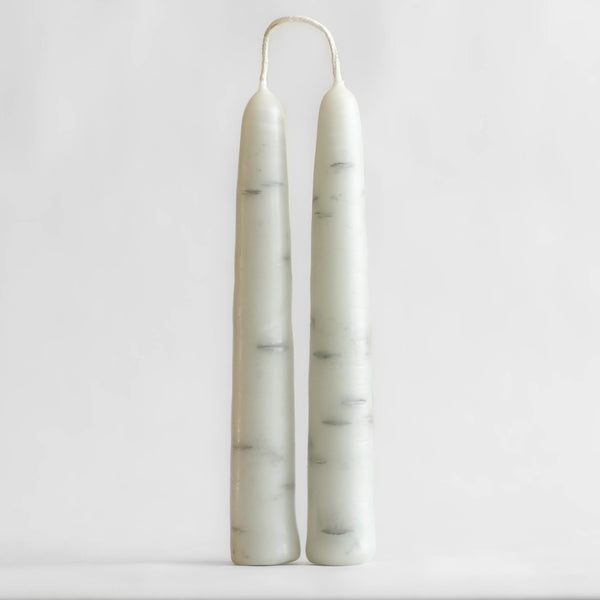 Photo of tethered pair of Birch Tree candles made of 100% Canadian beeswax, standing upright with white background.