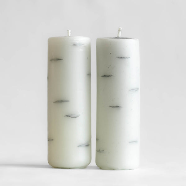 Photo of a pair of tall Birch Log candles made of 100% Canadian beeswax, standing upright with white background.